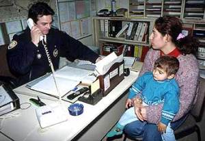 Mother and child in an office with an official